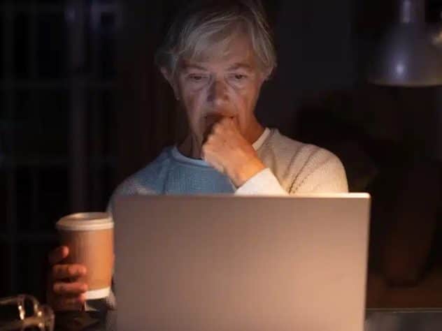 elderly woman browsing social media content at night